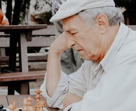 Elderly man playing chess