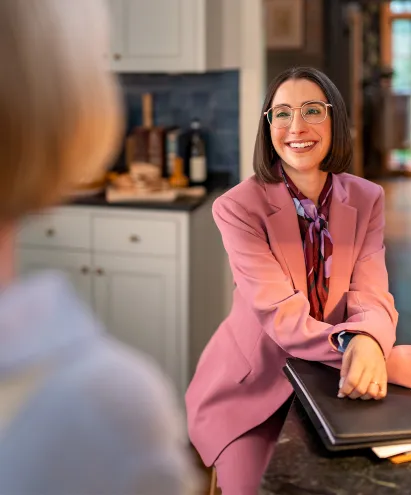 Female advisor in purple suit smiling