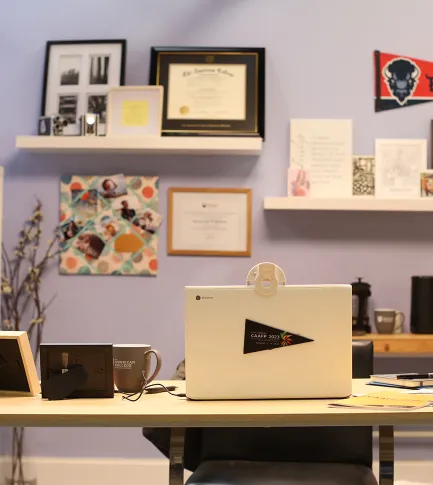 Photo of someone's office with banners and awards on the wall
