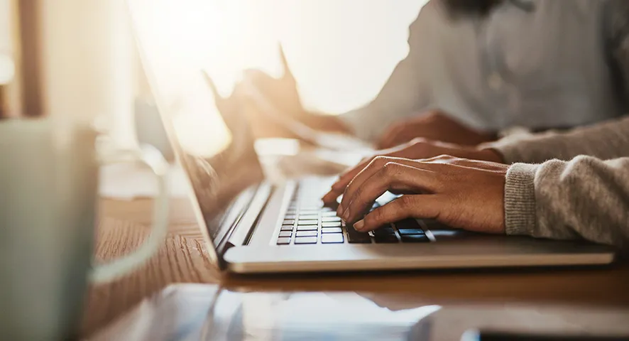 Man typing on laptop