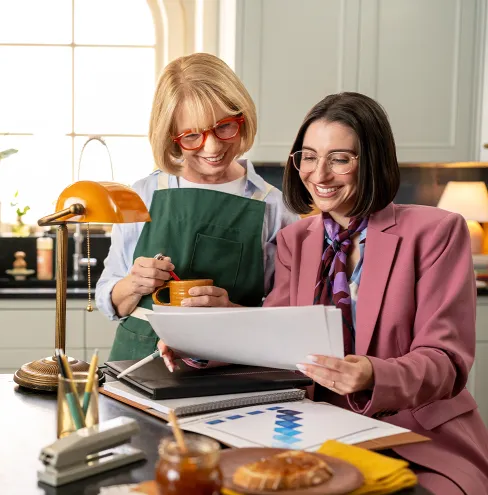 Elderly retired woman meeting with her advisor in the kitchen