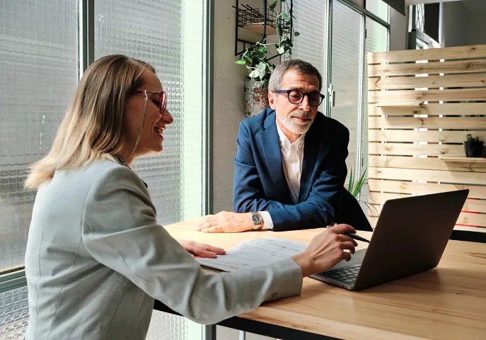 Advisor showing client information on her computer screen